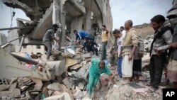 FILE - People inspect the rubble of houses destroyed by Saudi-led airstrikes in Sanaa, Yemen, Aug. 25, 2017. Airstrikes by a Saudi-led coalition targeted Yemen's capital early Friday, hitting at least three houses in Sanaa and killing dozens of civilians, including women and children, residents and eyewitnesses said. 