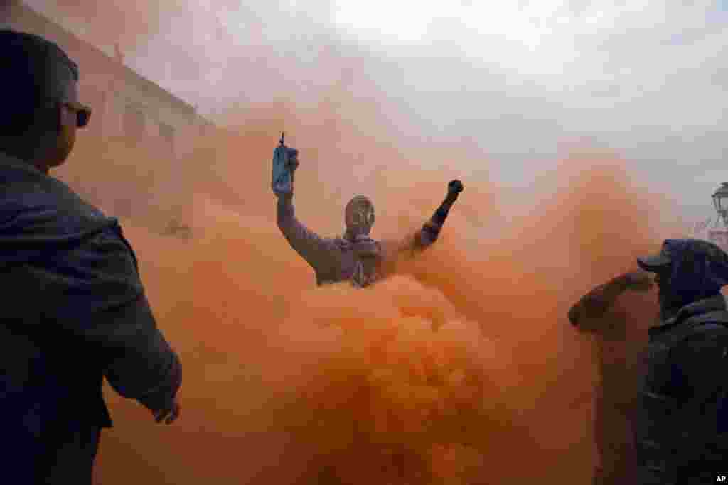 Revelers participate in the flour war, a unique colorful flour fight marking the end of the carnival season, in the port town of Galaxidi, some 200 kilometers (120 miles) west of Athens.