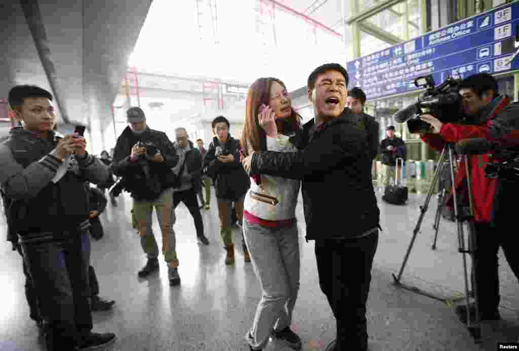 A relative of a passenger onboard Malaysia Airlines flight MH370 cries as she talks on her mobile phone at the Beijing Capital International Airport in Beijing, China. The Malaysia Airlines flight carrying 227 passengers and 12 crew lost contact with air traffic controllers en route from Kuala Lumpur to Beijing, the airline said in a statement.