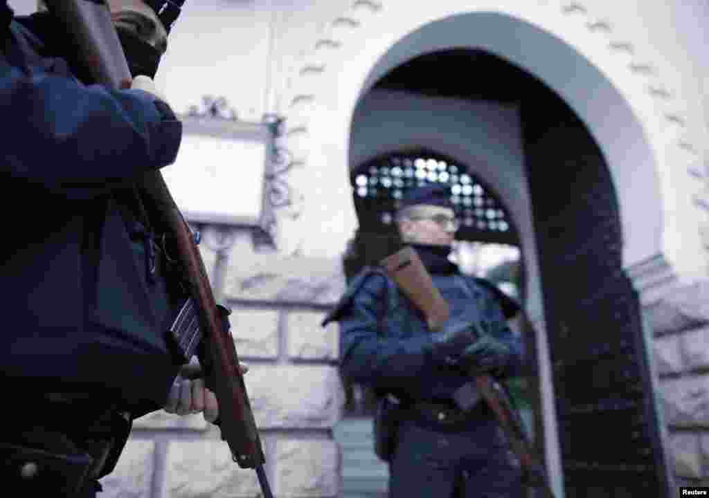 French police stand guard in front of the entrance of the Paris Grand Mosque as part of the highest level of the "Vigipirate" security plan after last week's Islamic militants attacks, Paris, France, Jan. 14, 2015.