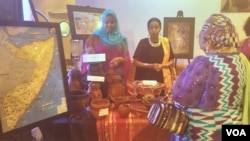 Nathifa Hashi, left, from Somalia explains items used by nomads in an exhibit at an Africa Day gala in Washington, May 27, 2016.