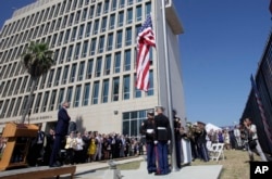 FILE - U.S. Secretary of State John Kerry watches the raising of the American flag at the newly opened U.S. Embassy in Havana, Cuba, Aug. 14, 2015.