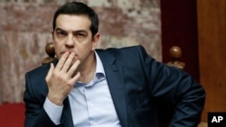 Greece's Prime Minister Alexis Tsipras gestures during a parliamentary session in Athens, March 30, 2015, after Tsipras called the special session of parliament to brief lawmakers on the course of recent troubled negotiations with bailout lenders to overhaul cost-cutting reforms.