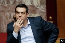 FILE - Greece's Prime Minister Alexis Tsipras gestures during a parliamentary session in Athens, March 30, 2015.