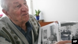 In this 2005 file photo Hitler's bodyguard, Rochus Misch, points on a picture of Adolf Hitler he had taken in Berchtesgarden, southern Germany.