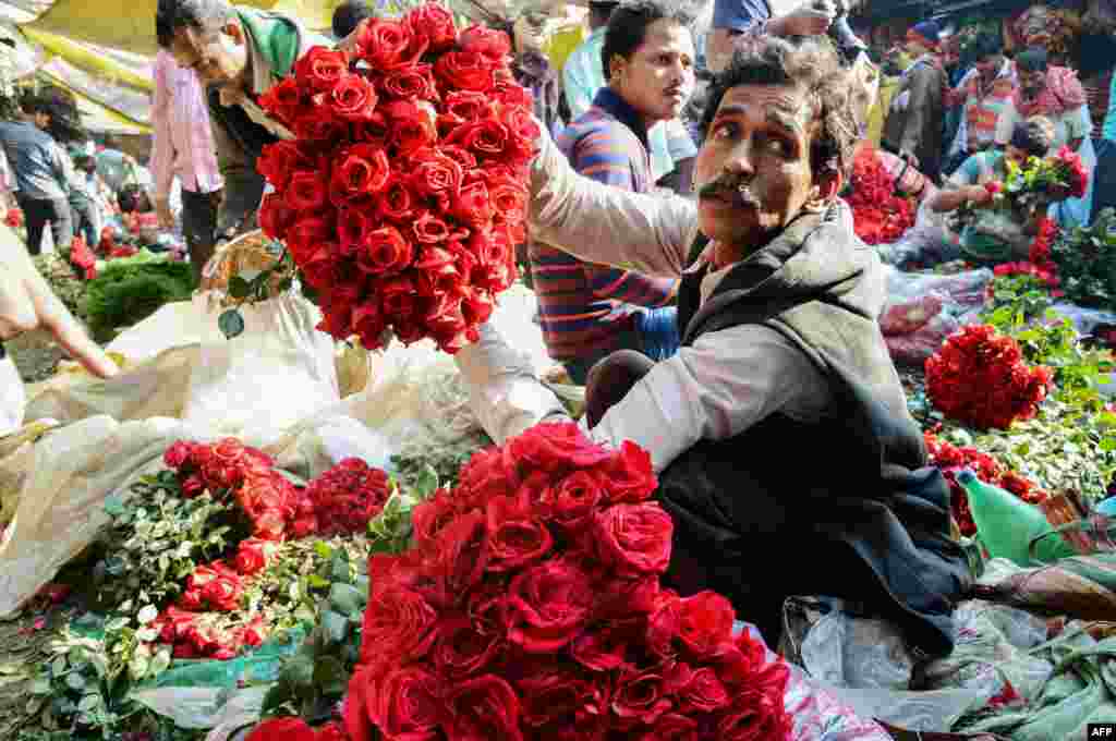 Indian flower vendors arrange roses as they wait for customers at a wholesale flower market in Kolkata. The roses are high in demand as seven days of festivity of the Valentine Week starts from Feb. 7 with Rose Day.