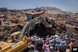 FILE - Rescuers work at the scene of a garbage landslide, on the outskirts of Addis Ababa, Ethiopia, March 12, 2017. A cause still has not been determined.