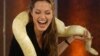 U.S.actress Angelina Jolie obviously does not have herptophobia, a deep fear of snakes and reptiles. She laughs while holding a snake on her shoulders during German television show. 