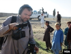 Boys observe as VOA cameraman Rahim Gul Sarwan prepares to shoot video in Achin district in eastern Afghanistan.