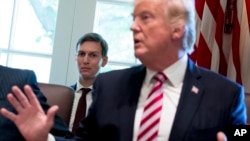FILE - White House Senior Adviser Jared Kushner listens at left as President Donald Trump speaks during a Cabinet meeting, June 12, 2017, in the Cabinet Room of the White House in Washington. 