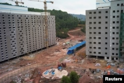 Pig buildings under construction are seen at Guangxi Yangxiang's farm at Yaji Mountain Forest Park in Guangxi province, China, March 19, 2018.
