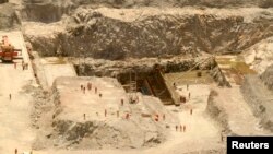 Laborers work at the Grand Renaissance dam in Guba Woreda, Benishangul Gumuz region March 16, 2014.