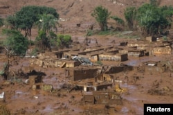 FILE - The Bento Rodrigues district is pictured covered with mud after a dam owned by Vale SA and BHP Billiton Ltd. burst in Mariana, Brazil, Nov. 6, 2015.