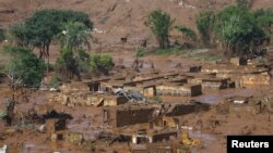 FILE - The Bento Rodrigues district is pictured covered with mud after a dam owned by Vale SA and BHP Billiton Ltd. burst in Mariana, Brazil, Nov. 6, 2015. 
