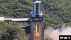 FILE - A demonstration of a new rocket engine for the geo-stationary satellite at the Sohae Space Center in this undated photo released by North Korea's Korean Central News Agency in Pyongyang, North Korea, Sept. 20, 2016. 