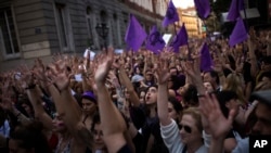 People lift up their arms as they shout slogans during a protest outside the Justice Ministry in Madrid, April 26, 2018. 