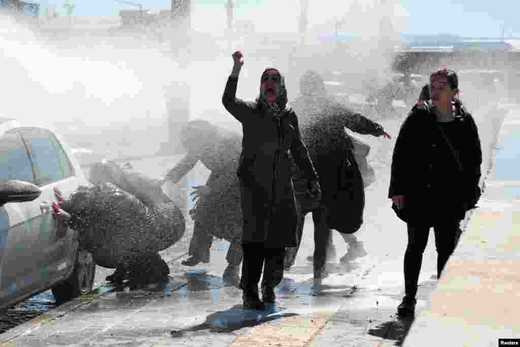 Turkish riot police use a water cannon to disperse demonstrators as they protest the death of a Kurdish inmate, in Diyarbakir.