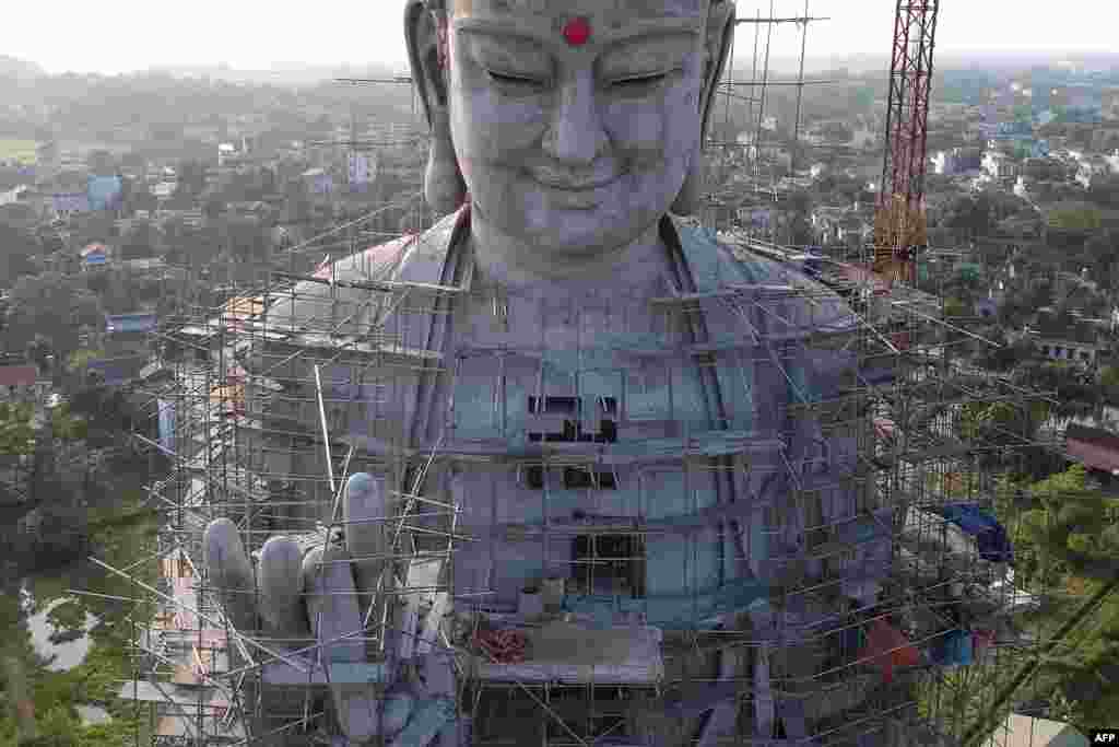 A giant Buddha statue at Khai Nguyen pagoda in Son Tay on the outskirts of Hanoi, Vietnam, is seen under construction, May 18, 2019.