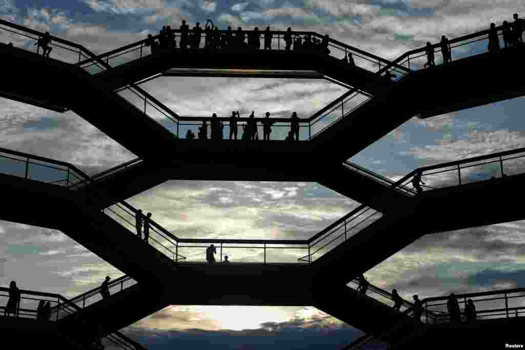 People tour inside &#39;The Vessel,&#39; a large public art sculpture made up of 155 flights of stairs at the Hudson Yards development - a residential, commercial, and retail space - on Manhattan&#39;s West side in New York City, May 26, 2019.