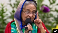 Re-elected Bangladeshi Prime Minister Sheikh Hasina gestures as she speaks with journalists in Dhaka, Bangladesh, Dec. 31, 2018. 