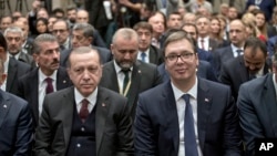 Turkish President Recep Tayyip Erdogan, front left, and his Serbian counterpart Aleksandar Vucic, front right, attend a Serbian-Turkish business forum in Belgrade, Serbia, Oct. 10, 2017.