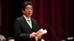 Japan's Prime Minister Shinzo Abe delivers a speech during the graduation ceremony of the National Defense Academy in Yokosuka, Kanagawa prefecture, Japan, March 18, 2018.