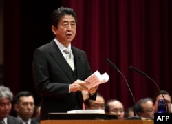 Japan's Prime Minister Shinzo Abe delivers a speech during the graduation ceremony of the National Defense Academy in Yokosuka, Kanagawa prefecture, Japan, March 18, 2018.
