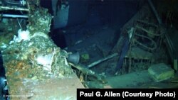 An image shot from a remotely operated underwater vehicle shows a spare parts box from USS Indianapolis on the floor of the Pacific Ocean in more than 16,000 feet of water.