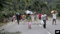 Residents evacuate to higher grounds at the flash flood-hit village of Andap, New Bataan township, Compostela Valley in southern Philippines, December 5, 2012.
