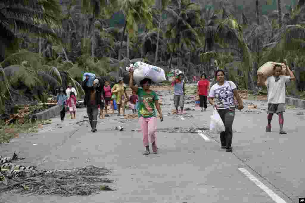 Residents evacuate to higher grounds at the flash flood-hit village of Andap, New Bataan township, Compostela Valley, Philippines, December 5, 2012.