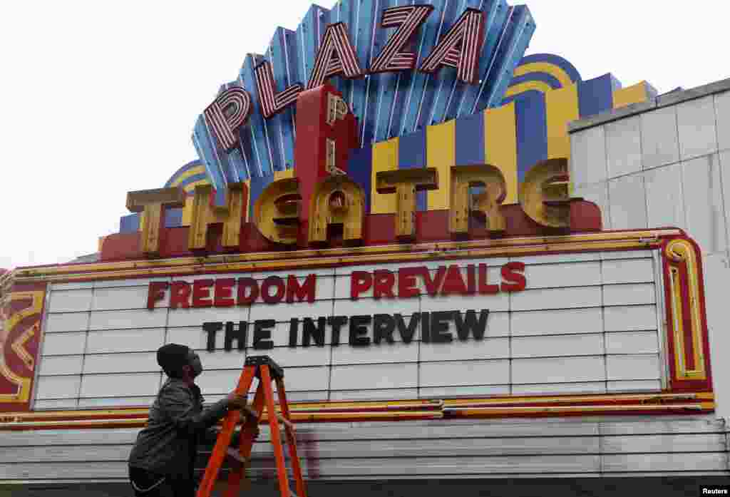 General Manager Brandon Delaney looks up at the marquee sign after the announcement that the Plaza Theatre would be showing the movie "The Interview" beginning Christmas Day in Atlanta, Georgia. Sony Pictures said it will release "The Interview" to a limited number of theaters on Dec. 25, less than a week after it canceled the comedy's release following a devastating cyberattack blamed on North Korea.