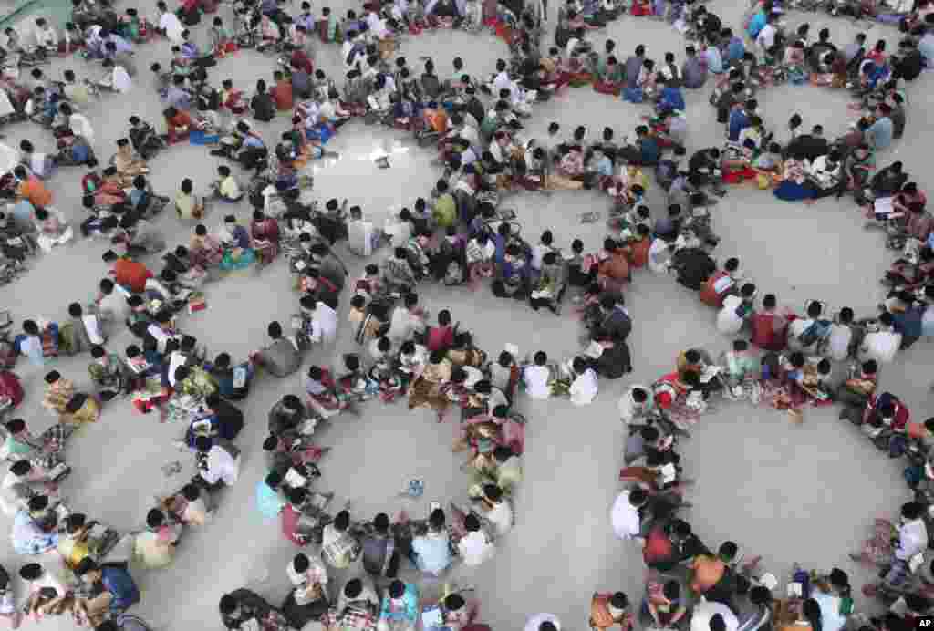 Students sit in circles during a Quran recital class on the first day of the holy fasting month of Ramadan at Ar-Raudlatul Hasanah Islamic boarding school in Medan, North Sumatra, Indonesia.