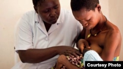 Nurse Koletha teaches Mwajuma how to breastfeed her one-day-old baby boy at the Lindi Regional Hospital, Tanzania. (Credit: Caroline Trutmann / Save the Children )
