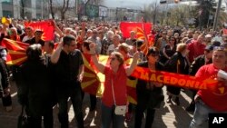 People protest in front of the EU office in Skopje, Macedonia, March 21, 2017. 