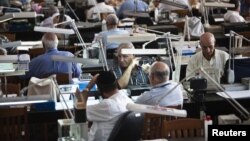Diamond dealers work on the trading floor of Israel's diamond exchange in Ramat Gan near Tel Aviv, October 30, 2012.