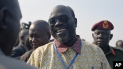 Ramadan Hassan Lako, head of a delegation of South Sudan's armed opposition, smiles upon arrival to the country's capital Juba after two year's in exile, Dec. 21, 2015.