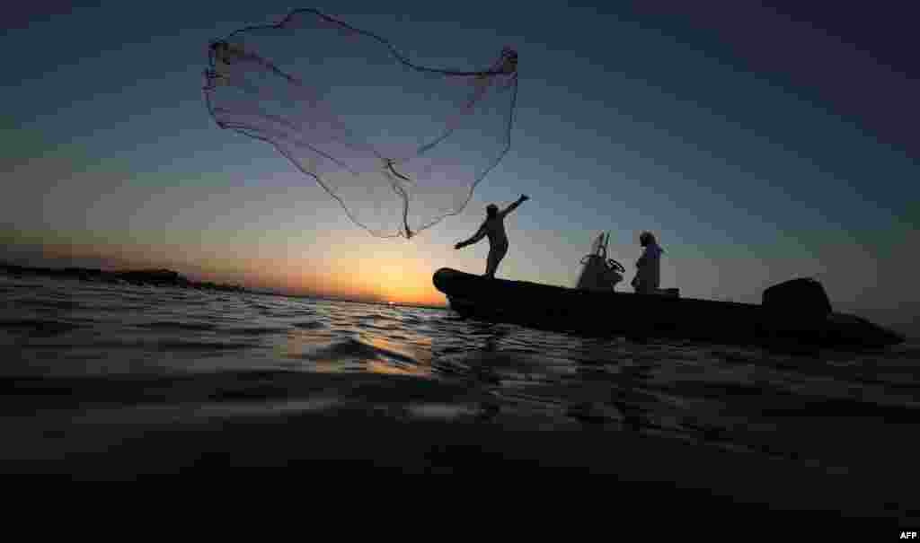 An Emirati fisherman throws his net near Mirfa, near the coast of the capital Abu Dhabi, UAE.