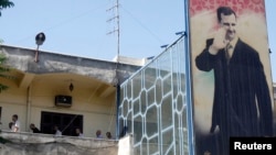 FILE - Syrian detainees, who were arrested for participating in protests against Syrian President Bashar al-Assad's regime, are seen at a detention facility in Damascus.