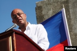 FILE - Haiti's President Michel Martelly addresses the audience during a memorial held for the victims of the 2010 earthquake in Titanyen, on the outskirts of Port-au-Prince, Jan. 12, 2015.
