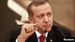 Turkey's Prime Minister Tayyip Erdogan talks to the media in Istanbul, Feb. 3, 2014. 