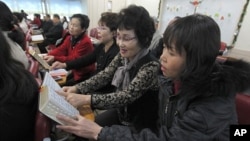 North Korean defectors sing hymns during a service at Saeteo Church in Seoul