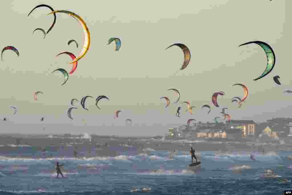 Surfers kitesurf in good wind and weather in Tableview, about 15km from the center of Cape Town, South Africa.