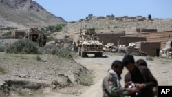 U.S. forces and Afghan commandos are seen in Asad Khil near the site of a U.S. bombing in the Achin district of Jalalabad, east of Kabul, Afghanistan, April 17, 2017. 