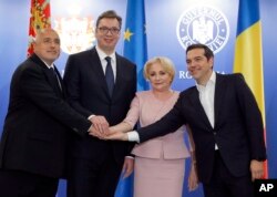 From left, Bulgarian Premier Boyko Borissov, Serbian President Aleksandar Vucic, Romanian Premier Viorica Dancila and Greek Premier Alexis Tsipras pose for media at the end of their meeting at the Victoria Palace, the Romanian government headquarters in Bucharest, Romania, April 24, 2018.