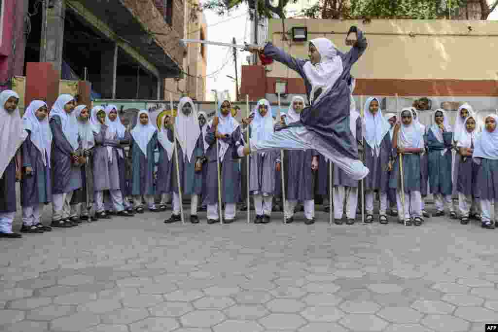 A Muslim girl does 'Vovinam', a Vietnamese martial art of self-defense by using swords and sticks, to perform for the upcoming International Women's Day, in Hyderabad, India.