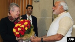 Chief Minister of the western Indian state of Gujarat and Bharatiya Janata Party (BJP) prime ministerial candidate Narendra Modi (R) presents a bouquet of flowers to US Ambassador to India Nancy Powell (L) as they meet in Gandhinagar in western Gujarat st