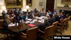 President Barack Obama drops by the first meeting of the Presidential Ambassadors for Global Entrepreneurship, with Commerce Secretary Penny Pritzker, in the Roosevelt Room of the White House, April 7, 2014. (Official White House Photo by Pete Souza)