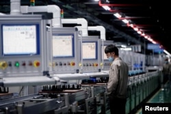 An employee works on the production line of electric vehicle (EV) battery manufacturer Octillion in Hefei, Anhui province, China March 30, 2021. REUTERS/Aly Song