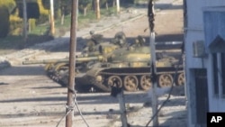 A Syrian tank is seen in Baba Amr near the city of Homs, February 12, 2012.
