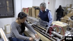 Tony Acosta and his staff produce nylon strings out of his 5,000-square-foot business in lower Manhattan, March 2016. (R. Taylor/VOA)